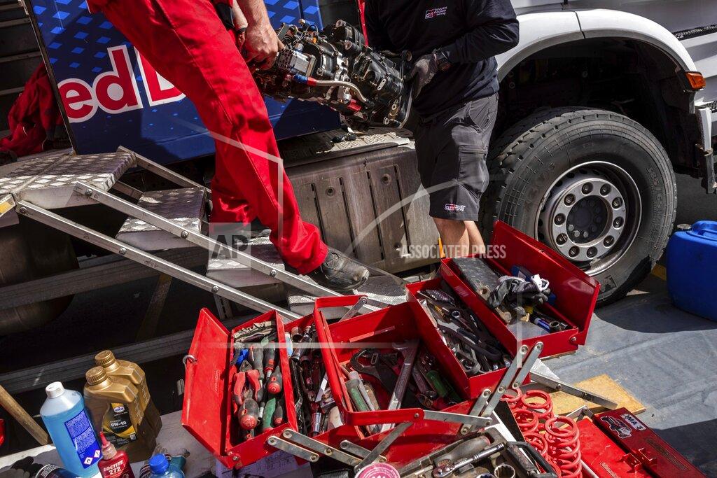 Bernat Armangue In this Saturday, Jan. 11, 2020 photo, Red Bull mechanics work at the Dakar Rally bivouac in Riyadh, Saudi Arabia. Formerly known as the Paris-Dakar Rally, the race was created by Thierry Sabine after he got lost in the Libyan desert in 1977. Until 2008, the rallies raced across Africa, but threats in Mauritania led organizers to cancel that year's event and move it to South America. It has now shifted to Saudi Arabia. The race started on Jan. 5 with 560 drivers and co-drivers, some on motorbikes, others in cars or in trucks. Only 41 are taking part in the Original category. (AP Photo/Bernat Armangue)