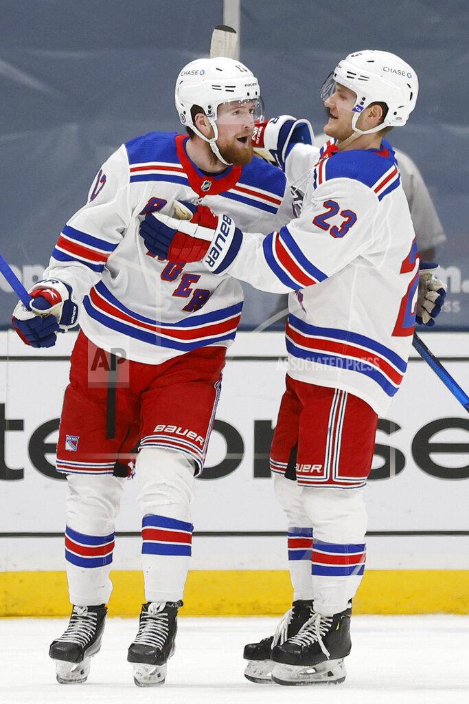 Jason Decrow New York Rangers' Alexis Lafreniere (13) celebrates with teammate Adam Fox (23) after scoring against the New York Islanders during the second period of an NHL hockey game Friday, April 9, 2021, in Uniondale, N.Y. (AP Photo/Jason DeCrow)