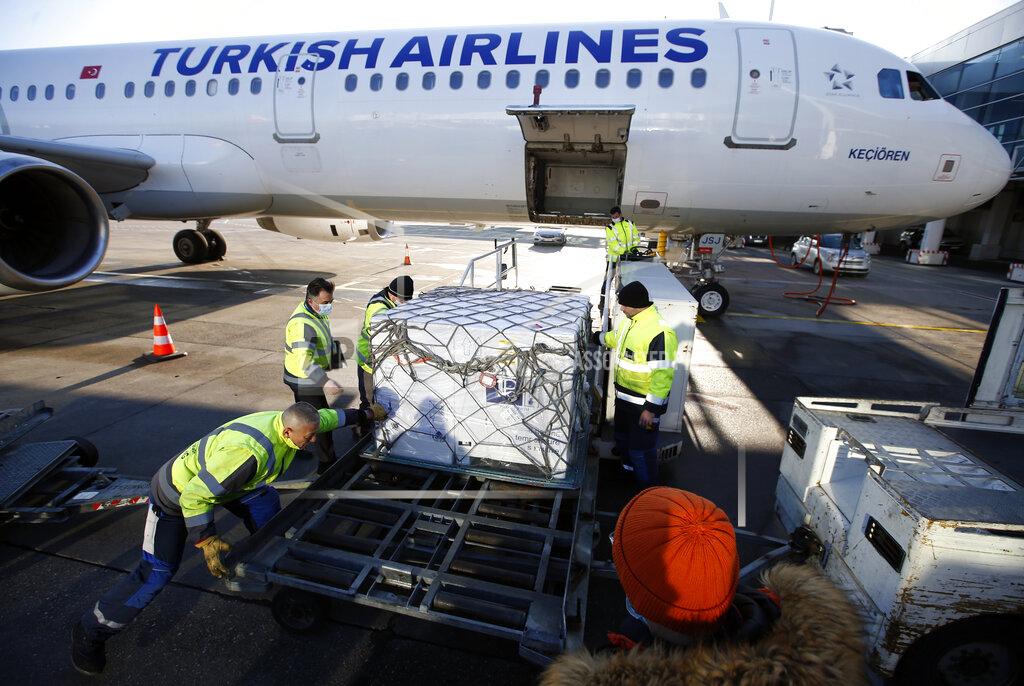 Darko Vojinovic Workers unload boxes of the Astra Zeneca vaccine at the Belgrade Airport, Serbia, Sunday, Feb. 21, 2021. 150,000 doses of Astra Zeneca vaccines were delivered to Serbia. (AP Photo/Darko Vojinovic)