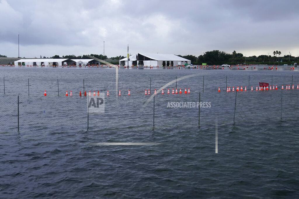Lynne Sladky A parking lot at Hard Rock Stadium, the site of one of the major COVID-19 testing sites in the state, is flooded in the aftermath of Tropical Storm Eta, Monday, Nov. 9, 2020, in Miami Gardens, Fla. The site suffered major damage due to extensive rain dumped by the storm, and will remain closed until Wednesday or Thursday. (AP Photo/Lynne Sladky)