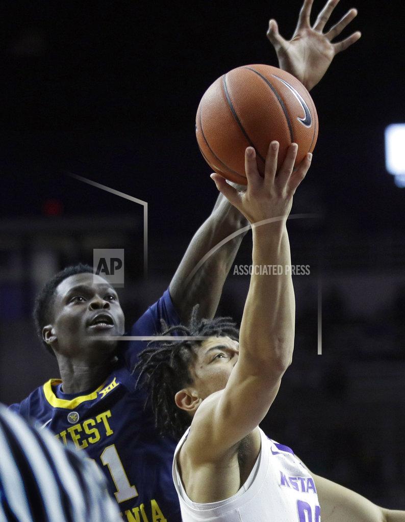 Orlin Wagner Kansas State guard Mike McGuirl (00) shoots after getting past West Virginia forward Wesley Harris (21) during the second half of an NCAA college basketball game in Manhattan, Kan., Wednesday, Jan. 9, 2019. (AP Photo/Orlin Wagner)