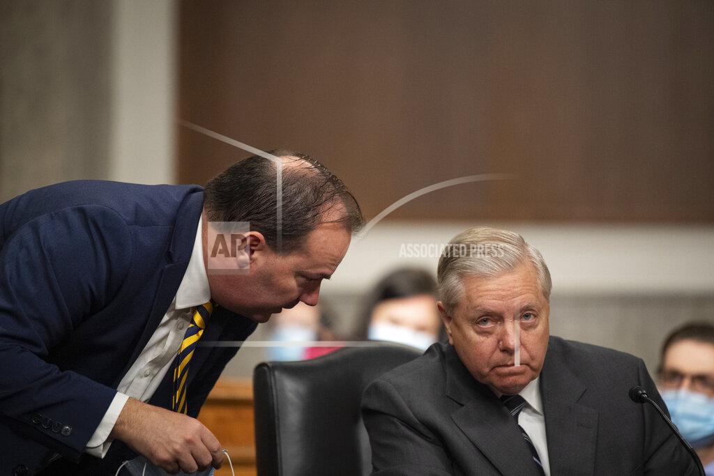 Caroline Brehman Sen. Mike Lee, R-Utah, left, speaks with Chairman Lindsey Graham, R-S.C., during a Senate Judiciary Committee Executive Business meeting, including the nomination of Amy Coney Barrett to serve as an associate justice on the Supreme Court of the United States, Thursday, Oct. 22, 2020, on Capitol Hill in Washington. (Caroline Brehman/Pool via AP)