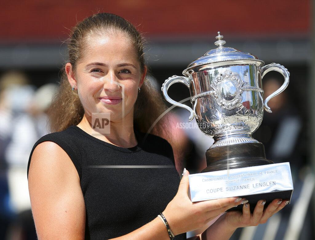 David Vincent FILE -- In this June 11, 2017 file photo Latvia's Jelena Ostapenko poses with the trophy during a photo call one day after winning the women's final match of the French Open tennis tournament, in Paris, France. With second-ranked Simona Halep joined by 2017 French Open champion Jeļena Ostapenko and last year’s Roland Garros finalist Markéta Vondroušová, this year’s Palermo Ladies Open, the Aug. 3-9 event marking the return of tour-level tennis following a five-month break for the coronavirus pandemic, will be like no other. (AP Photo/David Vincent)
