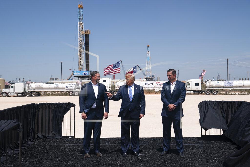 Evan Vucci President Donald Trump stands with Double Eagle Energy co-CEOs Cody Campbell, left, and John Sellers, right, as he arrives at the Double Eagle Energy Oil Rig, Wednesday, July 29, 2020, in Midland, Texas. (AP Photo/Evan Vucci)