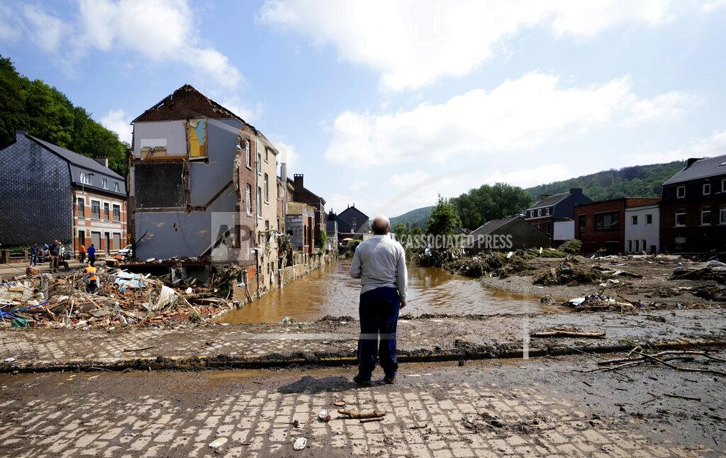 Virginia Mayo In this Saturday, July 17, 2021 file photo, a man stands on a bridge and surveys the damage after flooding in Pepinster, Belgium. Scientists say there’s something different this year from the recent drumbeat of climate weirdness. This summer a lot of the places hit by weather disasters are not used to getting extremes and many of them are wealthier, which is different from the normal climate change victims. That includes unprecedented deadly flooding in Germany and Belgium, 116-degree heat records in Portland, Oregon and similar blistering temperatures in Canada, along with wildfires. Now Southern Europe is seeing scorching temperatures and out-of-control blazes too. And the summer of extremes is only getting started. Peak Atlantic hurricane and wildfire seasons in the United States are knocking at the door. (AP Photo/Virginia Mayo, File)