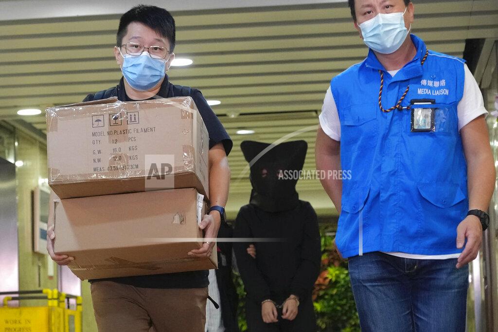 Vincent Yu Police officers leave a building with a hooded suspect, center, after searching evidence in Hong Kong Thursday, July 22, 2021. Hong Kong's national security police on Thursday arrested five people from a trade union of the General Association of Hong Kong Speech Therapists on suspicion of conspiring to publish and distribute seditious material, in the latest arrests made amid a crackdown on dissent in the city. (AP Photo/Vincent Yu)
