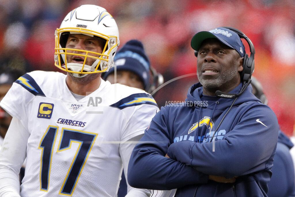 Charlie Riedel FILE - In this Sunday, Dec. 29, 2019 file photo, Los Angeles Chargers head coach Anthony Lynn stands next to quarterback Philip Rivers (17) during the second half of an NFL football game against the Kansas City Chiefs in Kansas City, Mo. Anthony Lynn will go into next season with a contract extension and a reworked coaching staff. The Los Angeles Chargers coach has signed an extension according to a team official, Tuesday, Feb. 4, 2020. (AP Photo/Charlie Riedel, File)