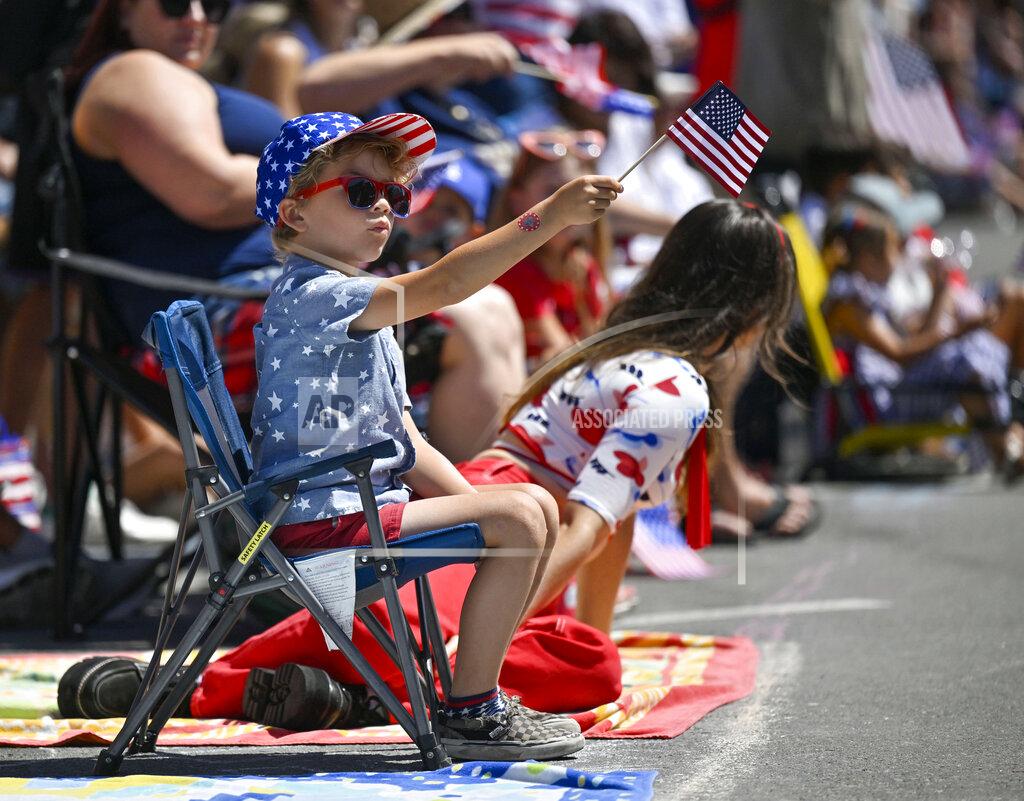 Jeff Gritchen Maverick Flores, 6, watches the 118th Huntington Beach 4th of July Parade in Huntington Beach, Calif.,, on Monday, July 4, 2022. (Jeff Gritchen/The Orange County Register via AP)
