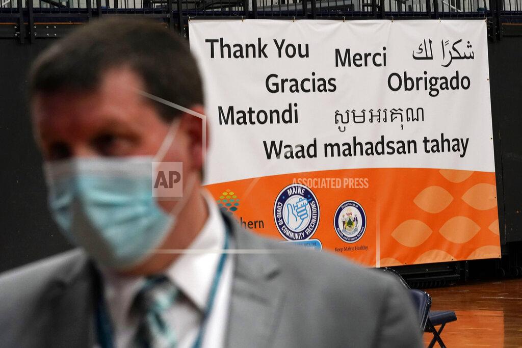 Robert F. Bukaty A banner thanks residents in several languages at a new community COVID-19 vaccination clinic at the Portland Expo, Monday, March 1, 2021, in Portland, Maine. (AP Photo/Robert F. Bukaty)
