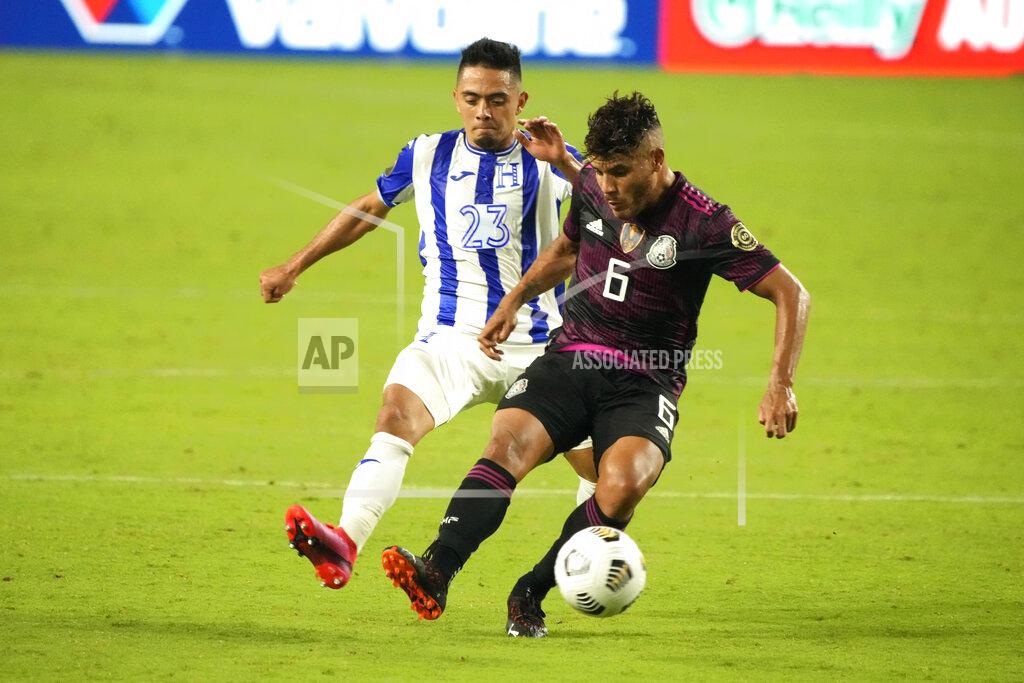 Rick Scuteri Mexico midfielder Jonathan Dos Santos (6) shields the ball from Honduras defenseman Diego Rodriguez during the second half of a CONCACAF Gold Cup soccer match Saturday, July 24, 2021, in Glendale, Ariz. (AP Photo/Rick Scuteri)