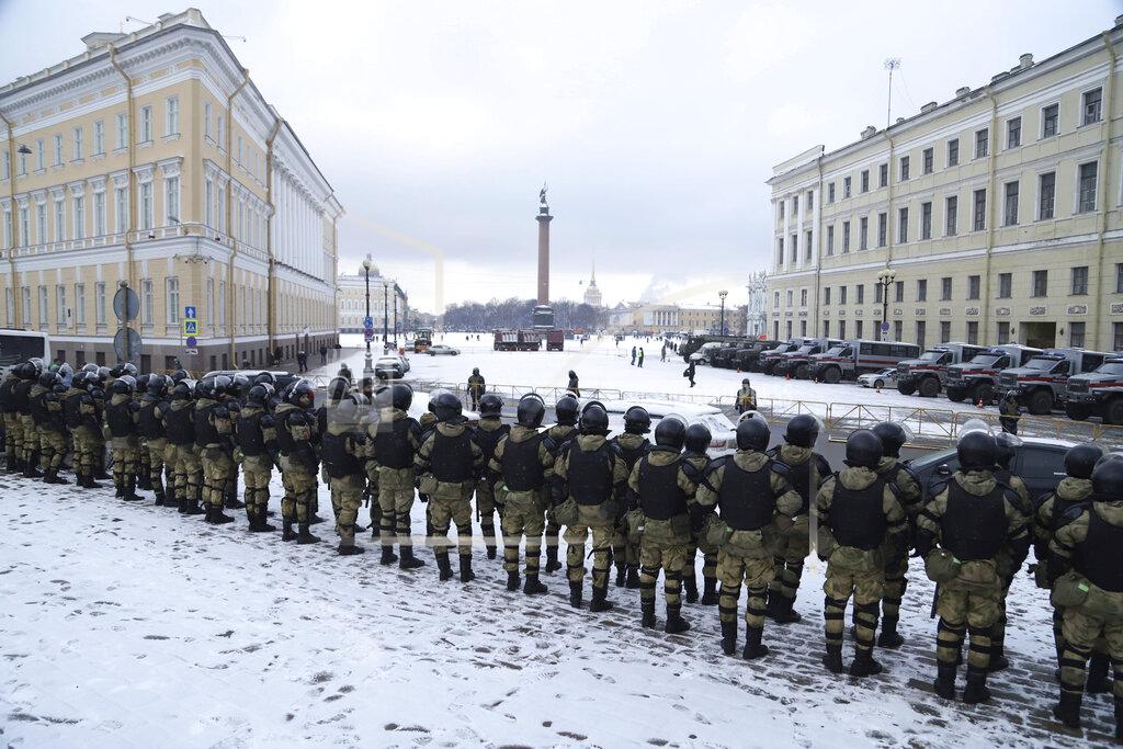Ivan Petrov Russian Rosguardia (National Guard) soldiers stand toward the Palace Square a day before of Sunday's protest in St. Petersburg, Russia, Saturday, Jan. 30, 2021. As part of a multipronged effort by the authorities to discourage Russians from attending Sunday's demonstrations, the Prosecutor General's office ordered the state communications watchdog, Roskomnadzor, to block the calls for joining the protests on the internet. The Prosecutor General's office and the Interior Ministry also issued stern warnings to the public not to join the protests, saying participants could face criminal charges of taking part in mass riots if the rallies turn violent. (AP Photo/Ivan Petrov)