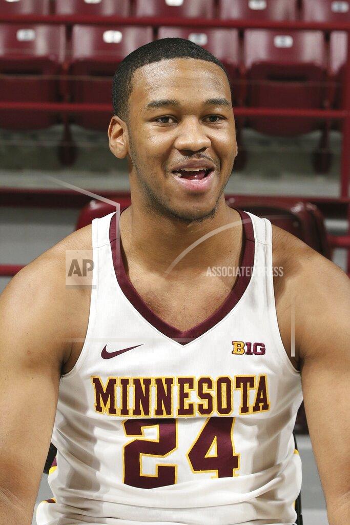 Minnesota power forward Eric Curry, who missed the 2017-18 college basketball season with a torn ACL in his left knee, visits with reporters during NCAA college basketball media day Friday, Oct. 18, 2019, in Minneapolis. This time he has a torn ACL in his right knee and is out for the season. (AP Photo/Jim Mone)