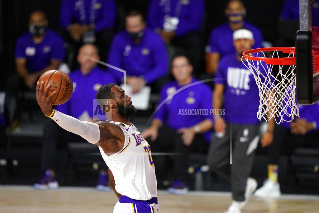 Mark J. Terrill FILE - In this Oct. 11, 2020, file photo, Los Angeles Lakers' LeBron James dunks during the first half in Game 6 of basketball's NBA Finals against the Miami Heat in Lake Buena Vista, Fla. James was announced Saturday, Dec. 26, as the winner of The Associated Press’ Male Athlete of the Year award for a record-tying fourth time. (AP Photo/Mark J. Terrill, File)