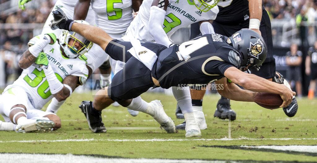 Willie J. Allen Jr. UCF quarterback Parker Navarro (14) dives into the end zone for a touchdown during an NCAA college football game against South Florida, Friday, Nov. 26, 2021, in Orlando, Fla. (Willie J. Allen Jr./Orlando Sentinel via AP)