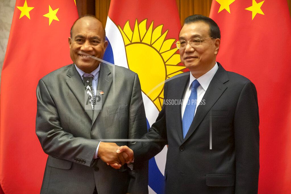 Mark Schiefelbein FILE - Kiribati's President Taneti Maamau, left, and Chinese Premier Li Keqiang pose for a photo before a meeting at the Great Hall of the People in Beijing, Monday, Jan. 6, 2020. China wants 10 small Pacific nations to endorse a sweeping agreement covering everything from security to fisheries in what one leader warns is a “game-changing” bid by Beijing to wrest control of the region. (AP Photo/Mark Schiefelbein, Pool, File)
