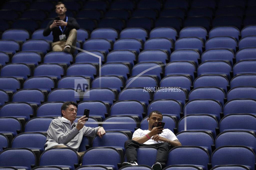 Gerry Broome A few fans sit in a mostly empty Greensboro Coliseum after the NCAA college basketball games were cancelled at the Atlantic Coast Conference tournament in Greensboro, N.C., Thursday, March 12, 2020. The biggest conferences in college sports all canceled their basketball tournaments because of the new coronavirus, seemingly putting the NCAA Tournament in doubt.(AP Photo/Gerry Broome)