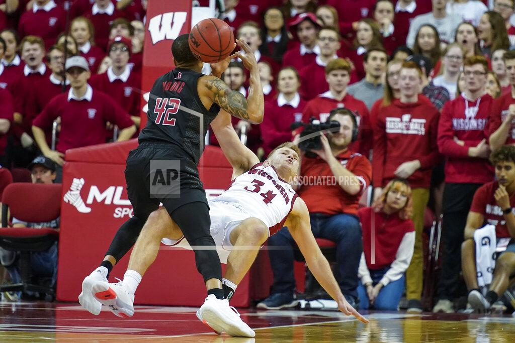 Andy Manis Wisconsin's Brad Davison (34) fouls Rutgers' Jacob Young (42) during the second half of an NCAA college basketball game Sunday, Feb. 23, 2020, in Madison, Wis. Wisconsin won 79-71. (AP Photo/Andy Manis)