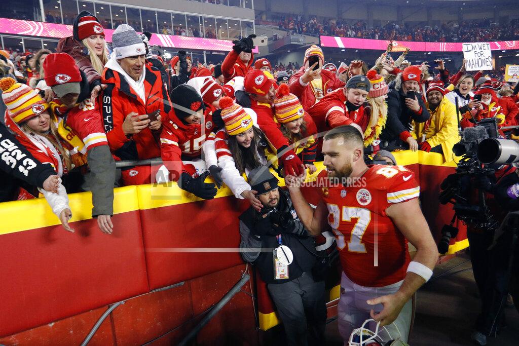 Colin E. Braley Kansas City Chiefs tight end Travis Kelce (87) celebrates with fans as he walks off the field after an NFL divisional round playoff football game against the Buffalo Bills, Sunday, Jan. 23, 2022, in Kansas City, Mo. The Chiefs won 42-36 in overtime. (AP Photo/Colin E. Braley)