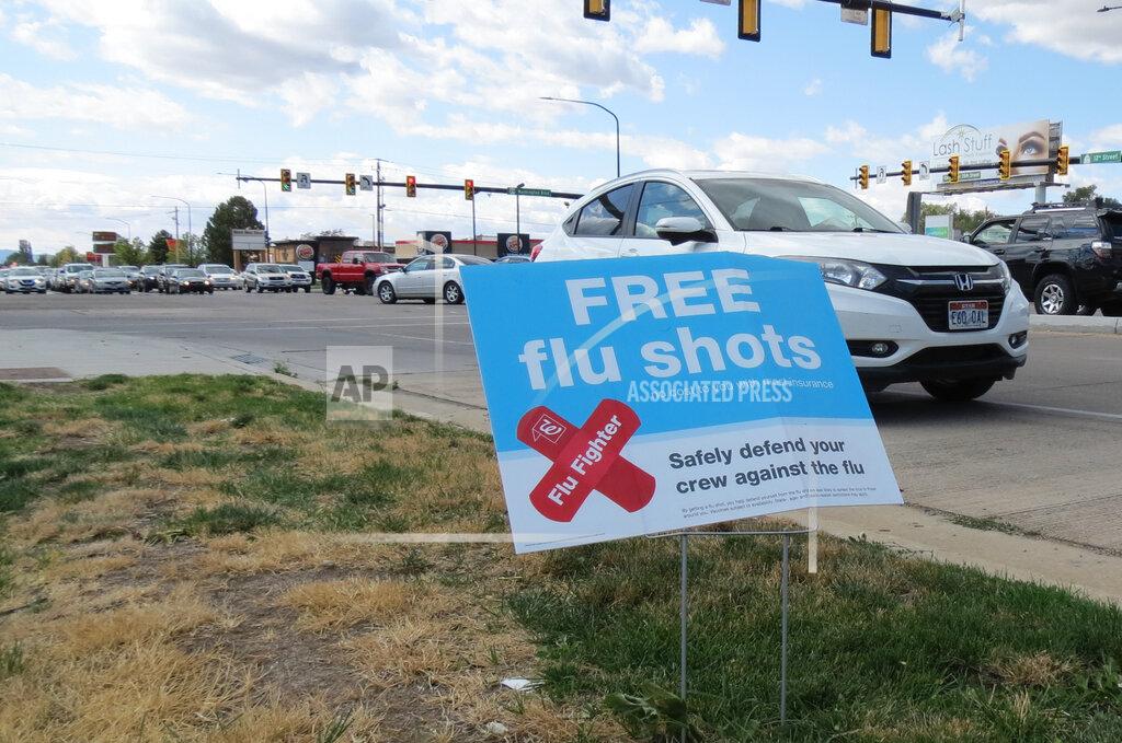 A sign advertising flu shots is displayed on Tuesday, Sept. 8, 2020, in in Ogden, Utah. The annual flu season is gearing up alongside the coronavirus pandemic, and Utah health officials are encouraging people to get their flu shots. (Tim Vandenack/Standard-Examiner via AP)