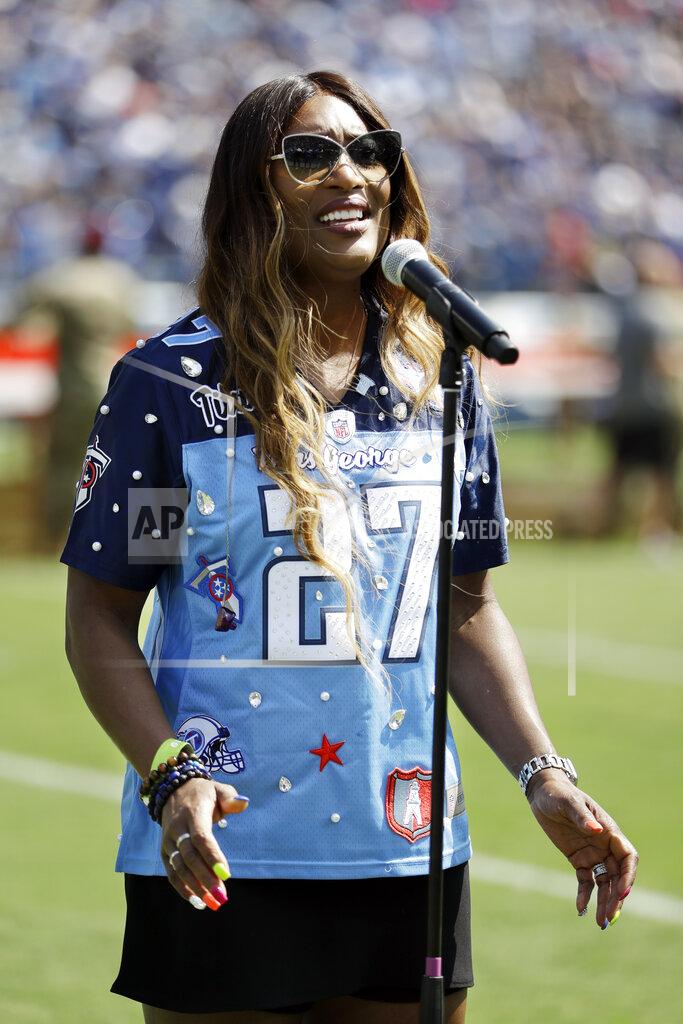 James Kenney Taj George, wife of former Tennessee Titans running back Eddie George, sings the national anthem before an NFL football game between the Titans and the Indianapolis Colts Sunday, Sept. 15, 2019, in Nashville, Tenn. Eddie George's number is to be retired at halftime. Taj George is a member of the R&B singing group Sisters with Voices. (AP Photo/James Kenney)