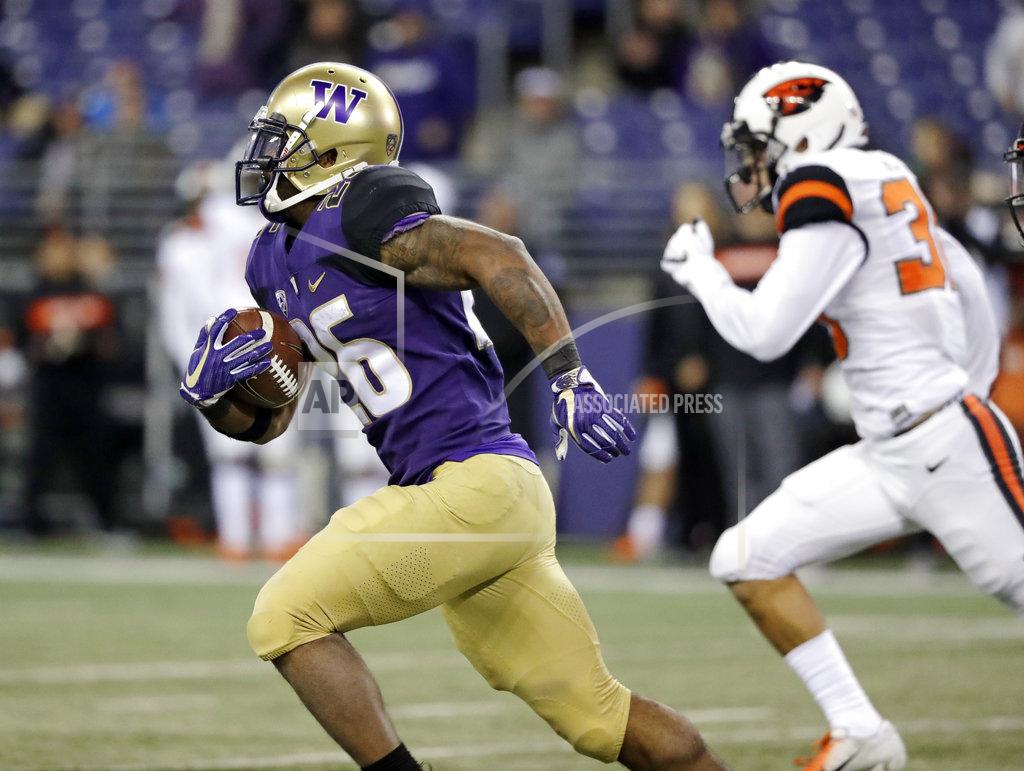 Elaine Thompson Washington's Salvon Ahmed, left, races against Oregon State for a 59-yard gain on a carry in the second half of an NCAA college football game Saturday, Nov. 17, 2018, in Seattle. (AP Photo/Elaine Thompson)