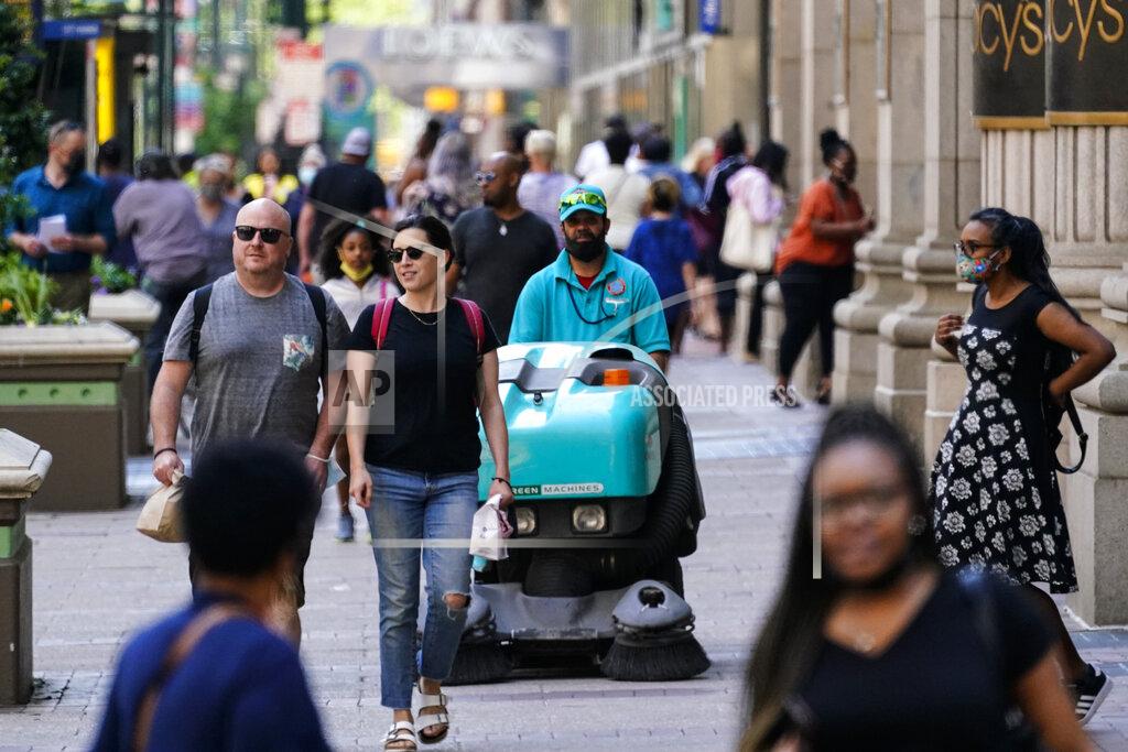 Matt Rourke People, some without masks, walk along Market Street in Philadelphia, Friday, May 21, 2021. (AP Photo/Matt Rourke)