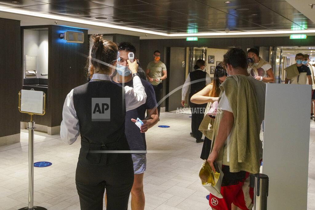 Andrew Medichini Passengers have their body temperature measured as they enter a restaurant of the MSC Grandiosa cruise ship in Civitavecchia, near Rome, Wednesday, March 31, 2021. MSC Grandiosa, the world's only cruise ship to be operating at the moment, left from Genoa on March 30 and stopped in Civitavecchia near Rome to pick up more passengers and then sail toward Naples, Cagliari, and Malta to be back in Genoa on April 6. For most of the winter, the MSC Grandiosa has been a lonely flag-bearer of the global cruise industry stalled by the pandemic, plying the Mediterranean Sea with seven-night cruises along Italy’s western coast, its major islands and a stop in Malta. (AP Photo/Andrew Medichini)