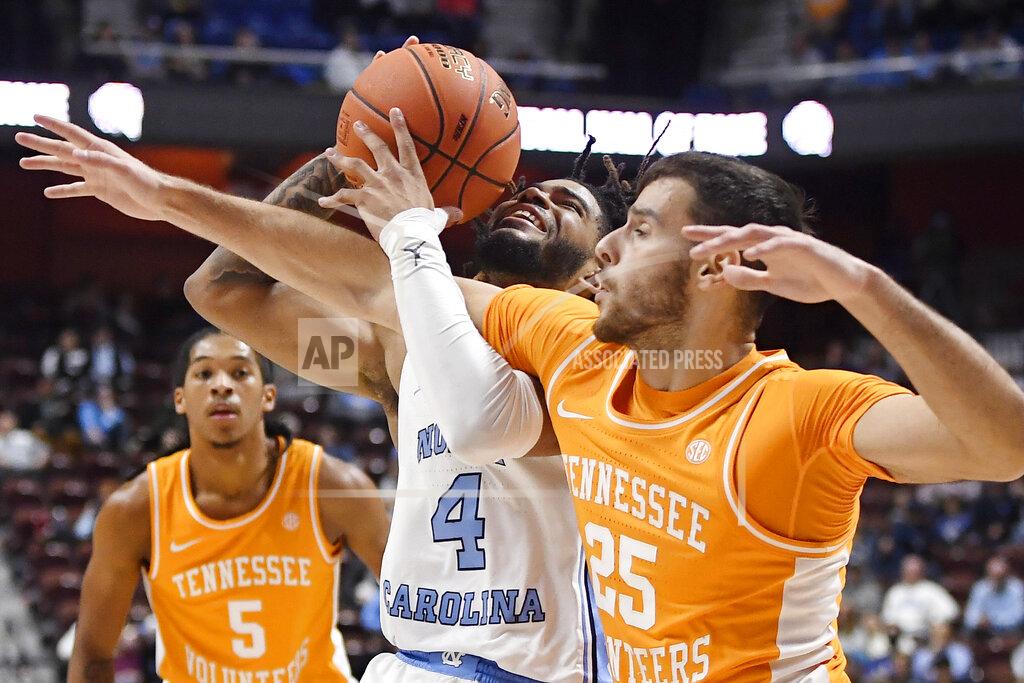 Jessica Hill North Carolina's R.J. Davis (4) is fouled by Tennessee's Santiago Vescovi (25) in the second half of an NCAA college basketball game, Sunday, Nov. 21, 2021, in Uncasville, Conn. (AP Photo/Jessica Hill)