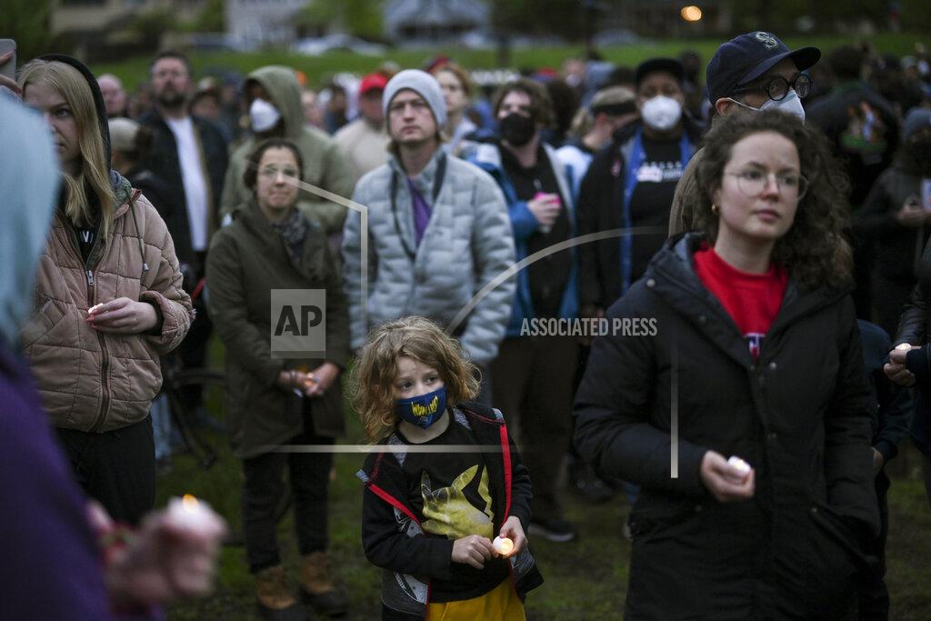 Aaron Lavinsky Community members hold candles during a vigil at the 'Say Their Names' cemetery Wednesday, May 25, 2022, in Minneapolis. The intersection where George Floyd died at the hands of Minneapolis police officers was renamed in his honor Wednesday, among a series of events to remember a man whose killing forced America to confront racial injustice. (Aaron Lavinsky/Star Tribune via AP)