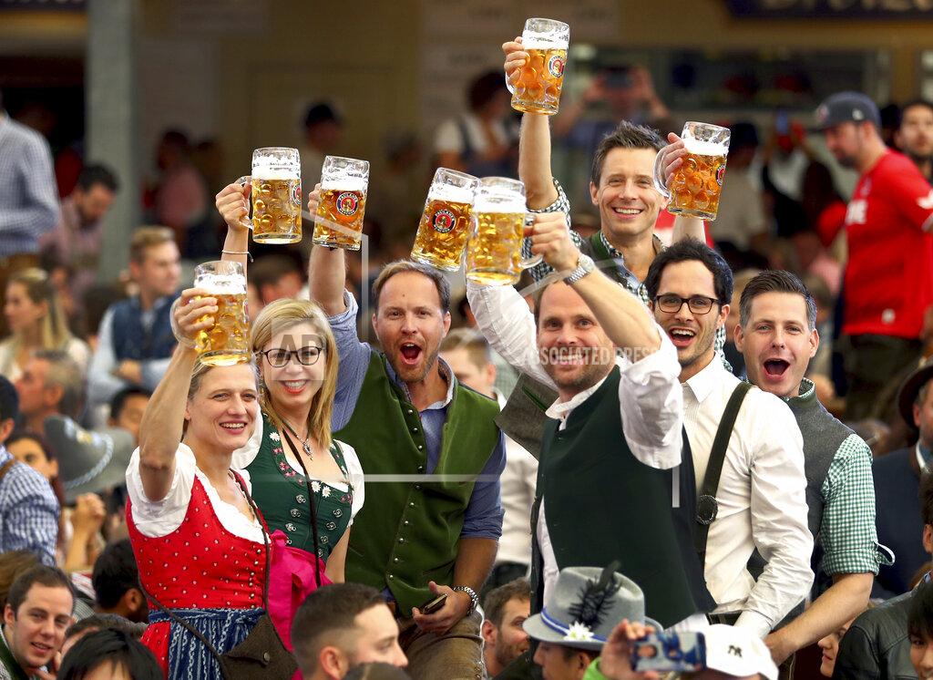 Matthias Schrader FILE - In this Saturday, Sept. 21, 2019 file photo, visitors lift glasses of beer during the opening of the 186th 'Oktoberfest' beer festival in Munich, Germany. Official data show that beer sales in Germany were down 5.5 percent last year, dragged lower by lengthy closures of bars and restaurants in the coronavirus pandemic. (AP Photo/Matthias Schrader, file)