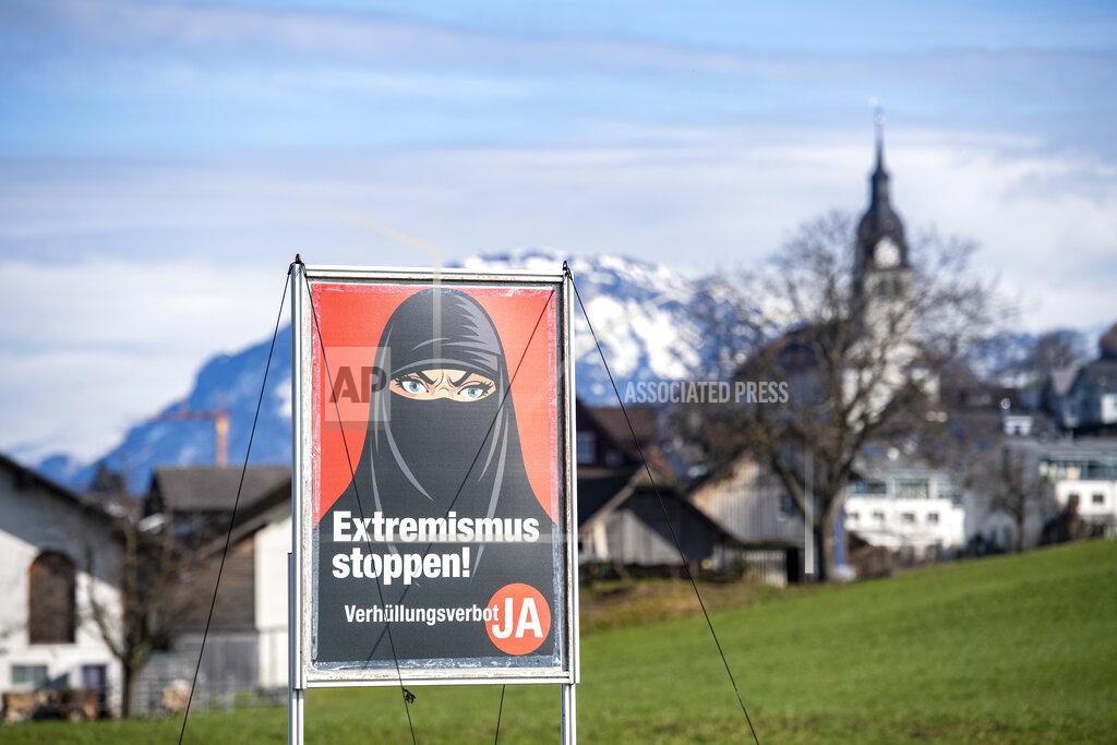 Urs Flueeler A poster supporting the initiative 'Yes to a ban on covering the face' is displayed at the village Buochs, Switzerland, Tuesday, Feb. 16, 2021. At a time when seemingly everyone in Europe is wearing masks to battle COVID-19, the Swiss go to the polls Sunday March 7, 2021, to vote on a long-laid proposal to ban face-coverings like niqabs and burqas worn by some Muslim women or by protesters in ski masks or bandannas. (Urs Flueeler/Keystone via AP)