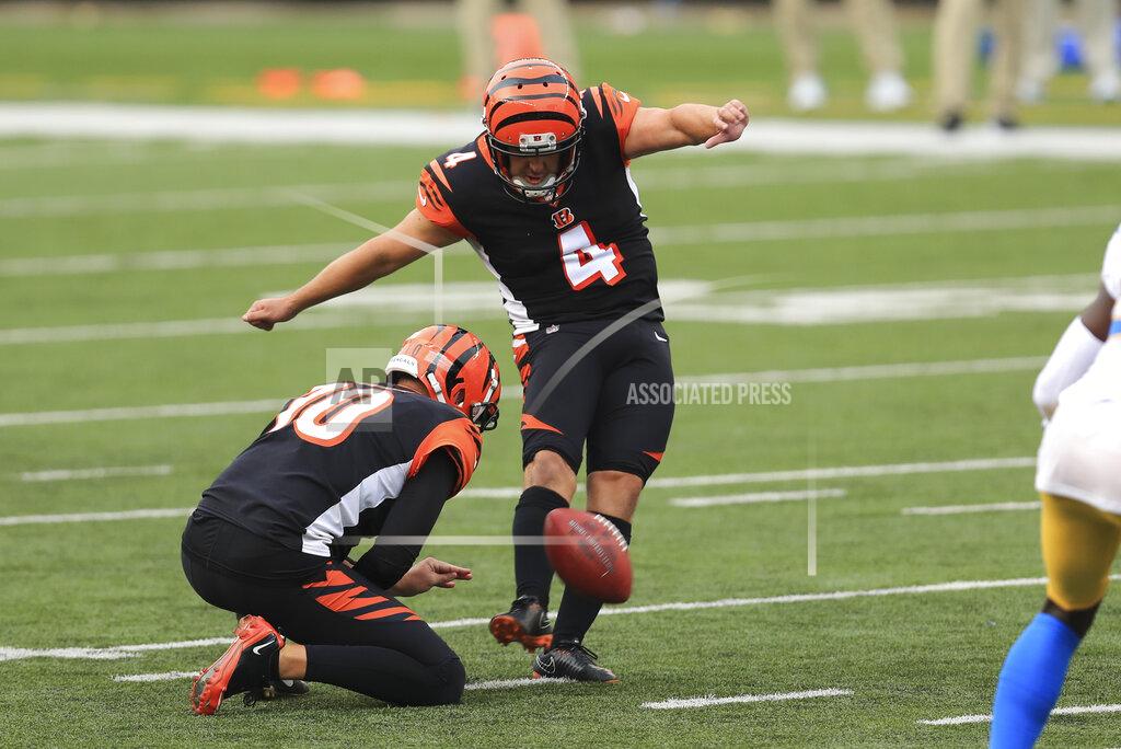 Aaron Doster Cincinnati Bengals kicker Randy Bullock (4) boots a field goal out of the hold of Kevin Huber (10) during the second half of an NFL football game against the Los Angeles Chargers, Sunday, Sept. 13, 2020, in Cincinnati. (AP Photo/Aaron Doster)