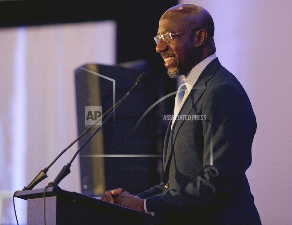 Akili-Casundria Ramsess Sen. Raphael Warnock, D-Ga., addresses the Gwinnett County Democratic Party fundraiser on Saturday, May 21, 2022 in Norcross, Ga. (AP Photo/Akili-Casundria Ramsess)