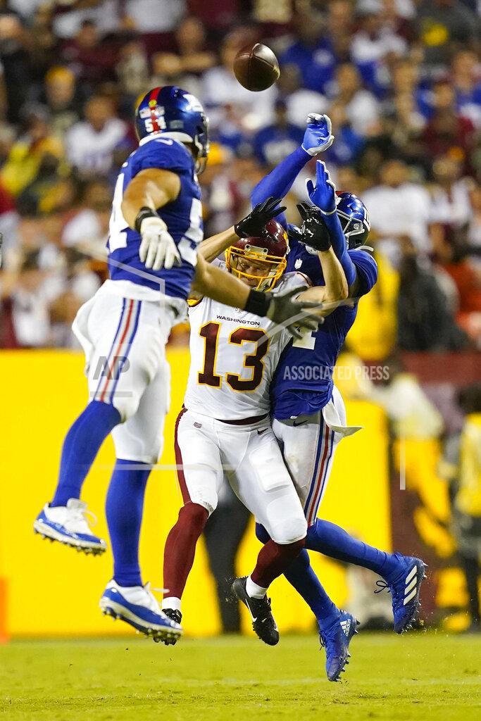 Patrick Semansky Washington Football Team wide receiver Adam Humphries (13) looses the ball as he is covered by New York Giants cornerback James Bradberry (24) and New York Giants inside linebacker Blake Martinez (54) during the second half of an NFL football game, Thursday, Sept. 16, 2021, in Landover, Md. (AP Photo/Patrick Semansky)