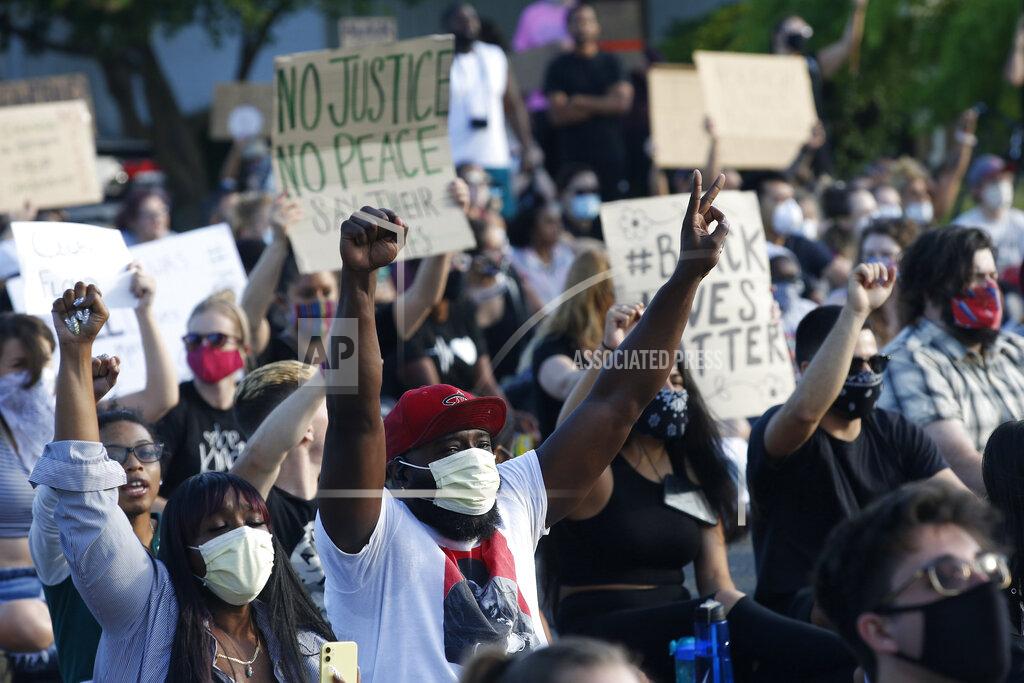 Rich Pedroncelli Protesters raise the arms Friday, June 5, 2020, as they say the name "George Floyd" during a demonstration near the home of Sacramento Mayor Darrell Steinberg in Sacramento, Calif. Floyd, a black man, died after being restrained by Minneapolis police officers on Memorial Day, May 25, 2020. (AP Photo/Rich Pedroncelli)