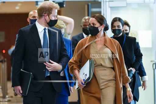 Prince Harry and Meghan, the Duke and Duchess of Sussex are escorted as they leave the United Nations headquarters after a visit during 76th session of the United Nations General Assembly, Saturday, Sept. 25, 2021. (AP Photo/Mary Altaffer)