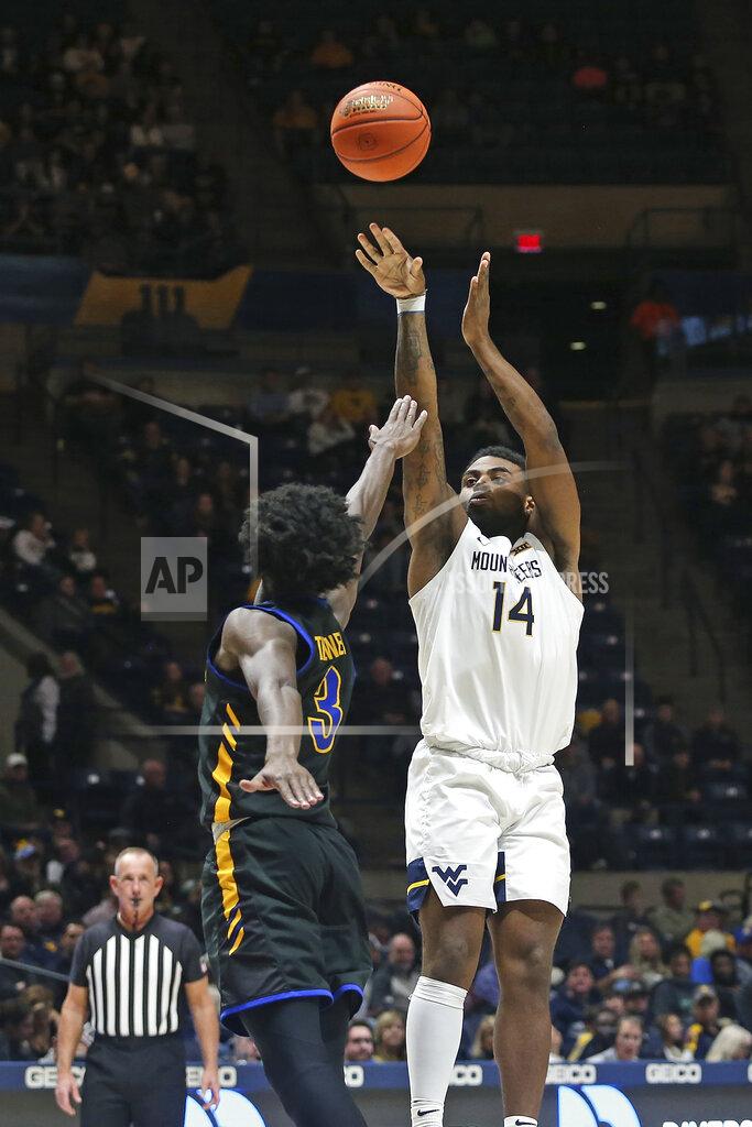 Kathleen Batten West Virginia guard Seth Wilson (14) shoots as Morehead State guard Drew Thelwell (3) defends during the second half of an NCAA college basketball game in Morgantown, W.Va., Tuesday, Nov. 15, 2022. (AP Photo/Kathleen Batten)