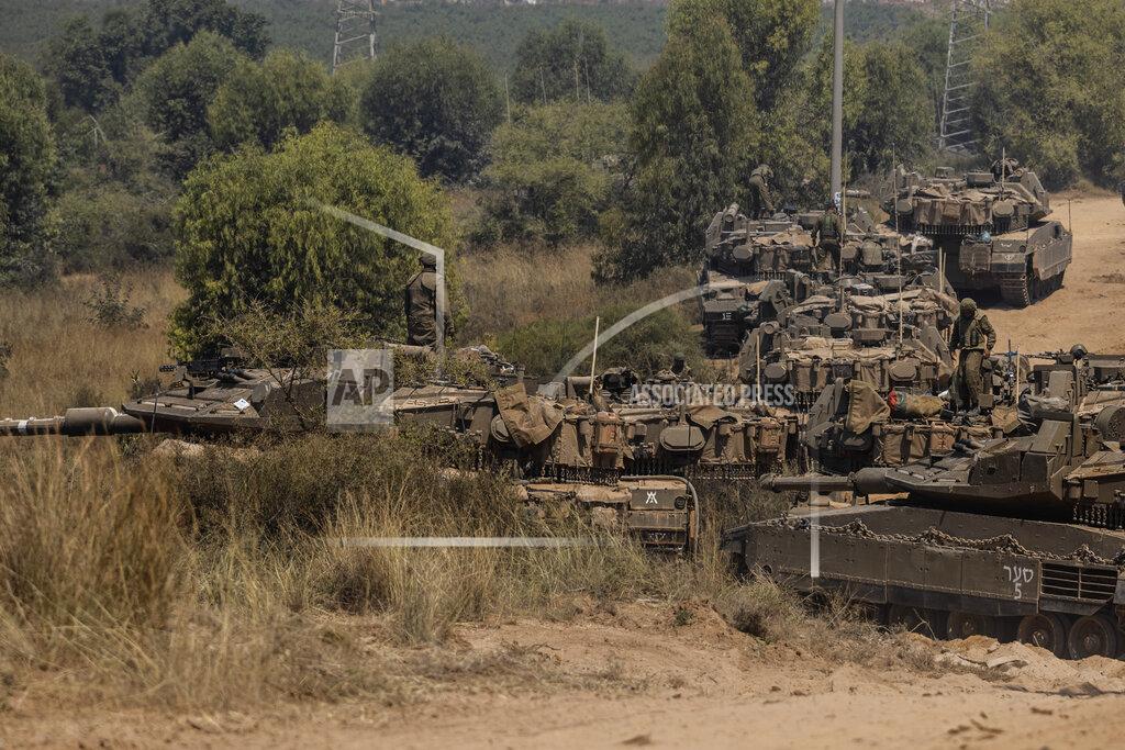 Tsafrir Abayov Israeli soldiers with armored vehicles gather in a staging ground near the border with Gaza Strip, southern Israel, May 14, 2021. (AP Photo/Tsafrir Abayov)