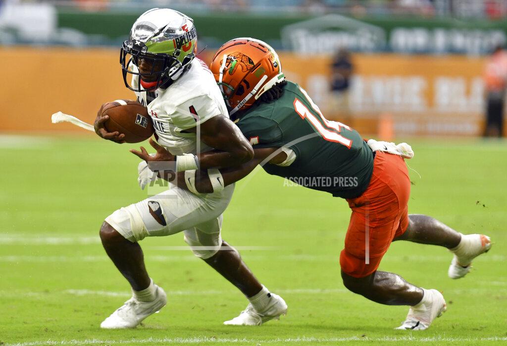 Jim Rassol Jackson State wide receiver Joshua Lanier (1) picks up a short gain as Florida A&M defensive back Trequan Butler (14) closes in for a tackle in the second quarter of an NCAA college football game, Sunday, Sept. 5, 2021, in Miami Gardens, Fla. (AP Photo/Jim Rassol)