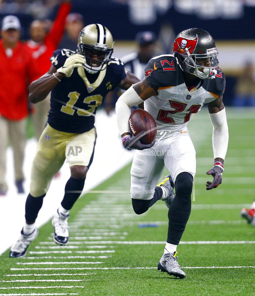 Butch Dill FILE - Tampa Bay Buccaneers defensive back Justin Evans (21) picks up a fumble and returns it for a touchdown as New Orleans Saints wide receiver Michael Thomas (13) pursues in the first half of an NFL football game in New Orleans, Sunday, Sept. 9, 2018. New Orleans Saints general manager Mickey Loomis says the club has agreed to free agent contracts with defensive end Taco Charlton and defensive back Justin Evans.(AP Photo/Butch Dill, File)