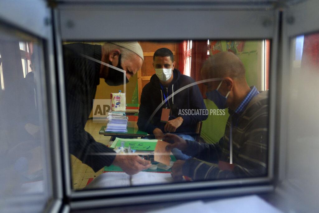 Toukik Doudou A man prepares to vote at a polling station during a vote for a revised constitution, in Algiers, Sunday, Nov. 1, 2020. Algerians are voting on whether to approve a revised constitution that imposes term limits and aims at answering demands from pro-democracy protesters who pushed out the president last year. (AP Photo/Toufik Doudou)