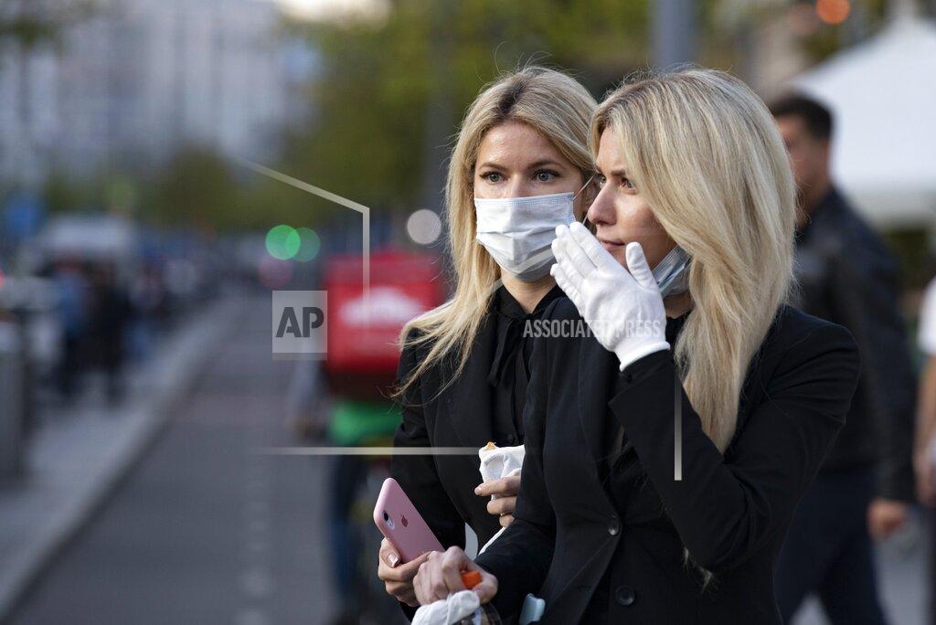 Alexander Zemlianichenko Two women wearing face masks against coronavirus as wait to cross the road in the center of in Moscow, Russia, Wednesday, Sept. 23, 2020. Russia confirmed over six and half thousand new Covid-19 cases Wednesday, bringing the country's official number of cases to 1,122,241 as the number of new infections across the country continues to rise. (AP Photo/Alexander Zemlianichenko)