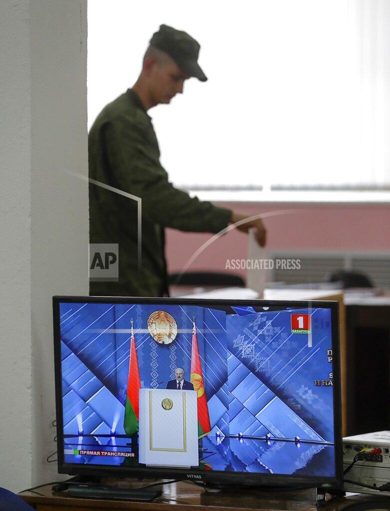 Sergei Grits A Belarusian soldier votes at a polling station during a early voting ahead of Sunday's election while live broadcast of Belarus President Alexander Lukashenko's speech in Minsk, Belarus, Tuesday, Aug. 4, 2020. Belarus's authoritarian leader is vowing to maintain a close alliance with Russia despite the latest tensions as he seeks a sixth term in office amid a surge of opposition protests. President Alexander Lukashenko's comments in a state-of-the-nation address ahead of Sunday's election contrast with his diatribes against Russia last week. (AP Photo/Sergei Grits)