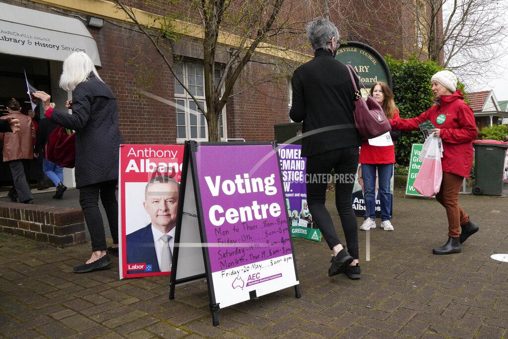 Mark Baker Voters walk into a pre-polling booth in Sydney, Australia, Friday, May 20, 2022. Australians will go to the polls Saturday following a six-week election campaign that has focused on pandemic-fueled inflation, climate change and fears of a Chinese military outpost being established less than 1,200 miles off Australia's shore. (AP Photo/Mark Baker)