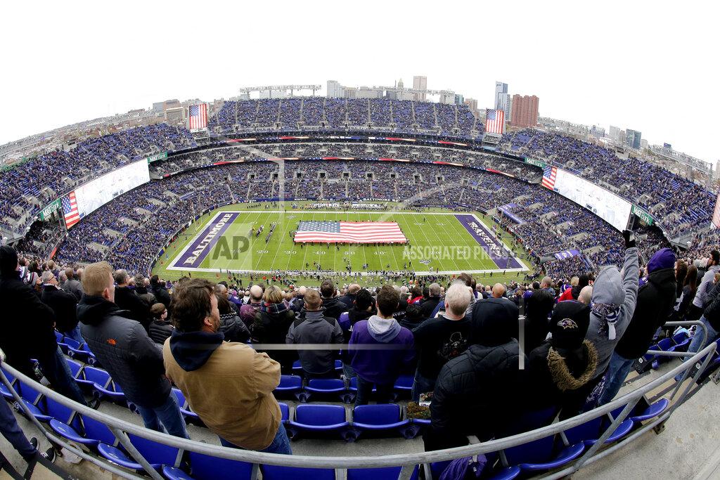 Julio Cortez U.S. service members hold a large flag on the field at M&T Bank Stadium as part of the Baltimore Ravens' Salute to Service prior to an NFL football game against the Houston Texans, Sunday, Nov. 17, 2019, in Baltimore. (AP Photo/Julio Cortez)