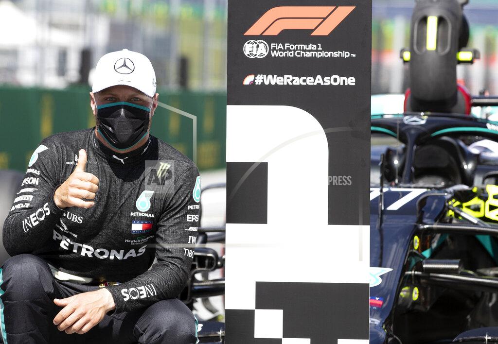 Mark Thompson Mercedes driver Valtteri Bottas of Finland, wearing a mask against the spread of the coronavirus, poses after he clocked the fastest time during the qualifying session at the Red Bull Ring racetrack in Spielberg, Austria, Saturday, July 4, 2020. The Austrian Formula One Grand Prix will be held on Sunday. (Mark Thompson/Pool via AP)