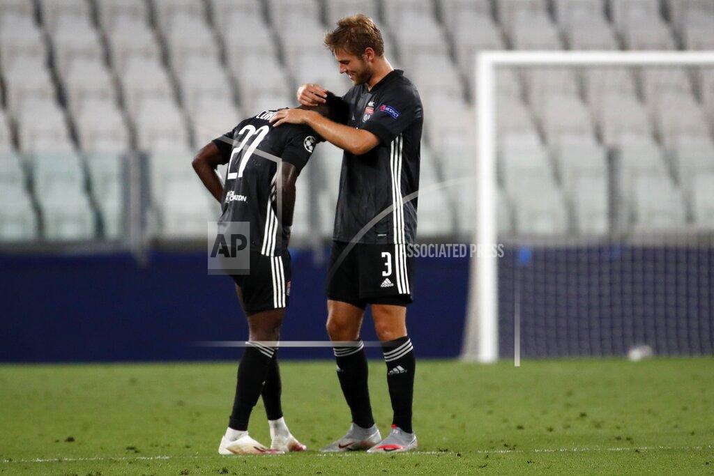 Antonio Calanni Lyon players celebrate after the Champions League round of 16 second leg, soccer match between Juventus and Lyon at the Allianz stadium in Turin, Italy, Friday, Aug. 7, 2020. Lyon will play in the quarter finals. (AP Photo/Antonio Calanni)