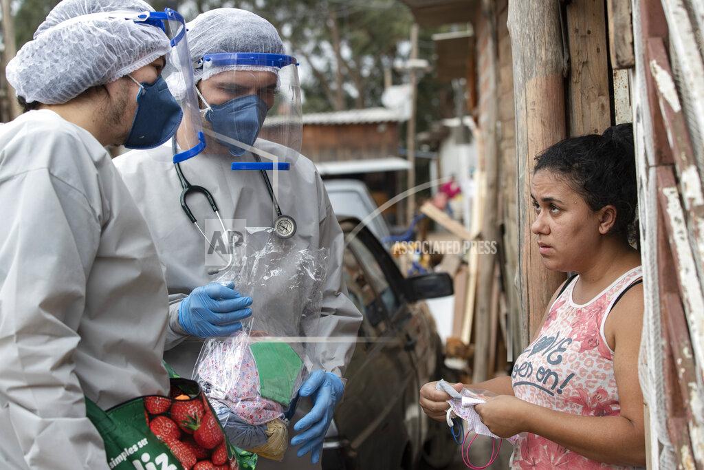 Andre Penner Health workers from Doctors Without Borders visit a squatters camp to conduct medical examinations and avoid the spread of the COVID-19 in Sao Bernardo do Campo, greater Sao Paulo area, Brazil, Wednesday, June 3, 2020. (AP Photo/Andre Penner)