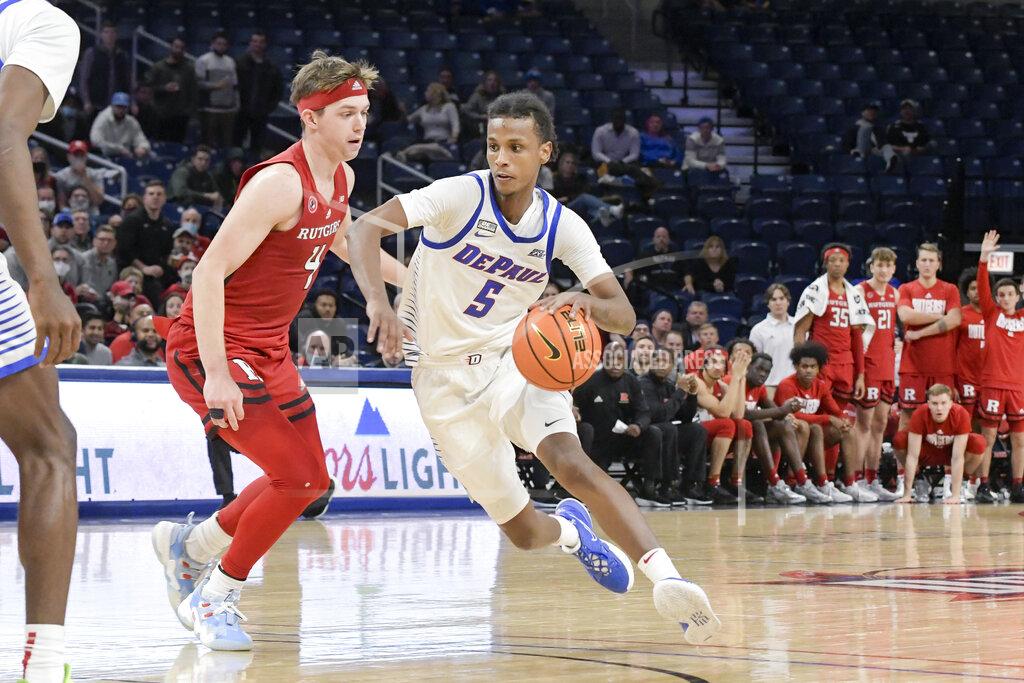 Mark Black DePaul's Philmon Gebrewhit (5) drives around Rutgers' Paul Mulcahy (4) during the second half of an NCAA college basketball game Thursday, Nov. 18, 2021, in Chicago. (AP Photo/Mark Black)