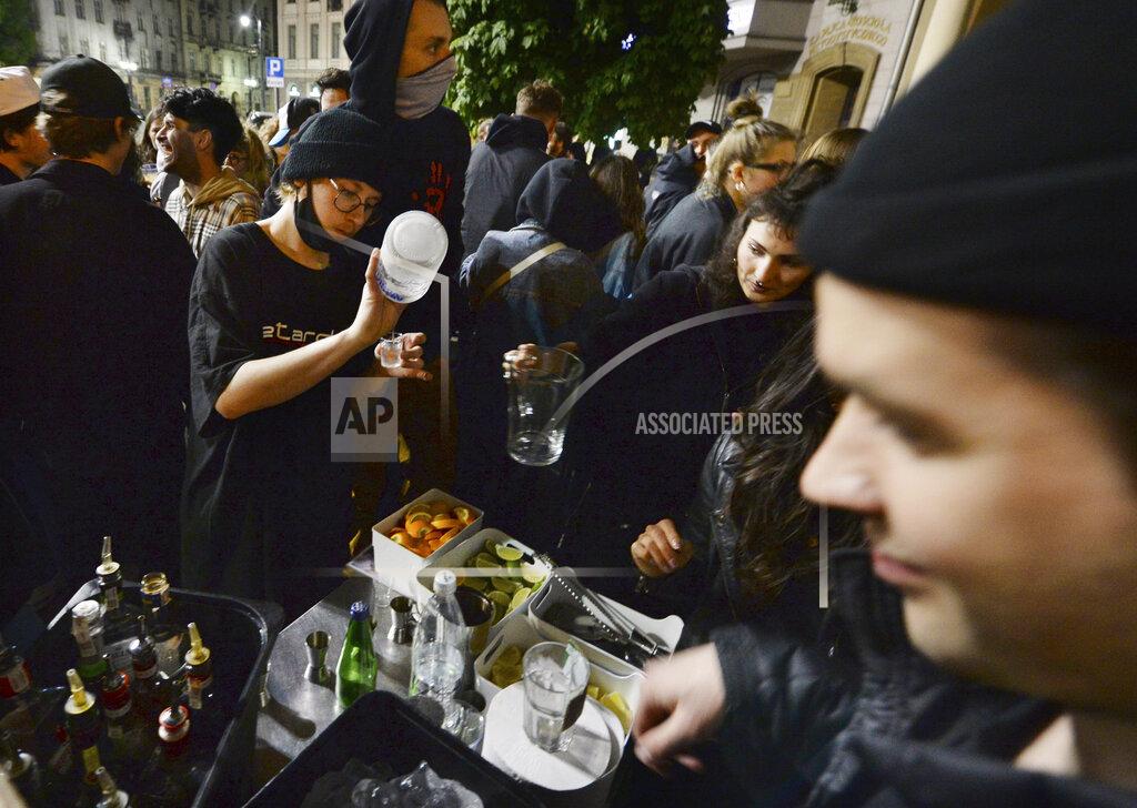 Czarek Sokolowski People gather and celebrate as bars, clubs and other establishments reopened in Poland after being closed for seven months, in Warsaw, Poland, Friday, May 14, 2021. (AP Photo/Czarek Sokolowski)